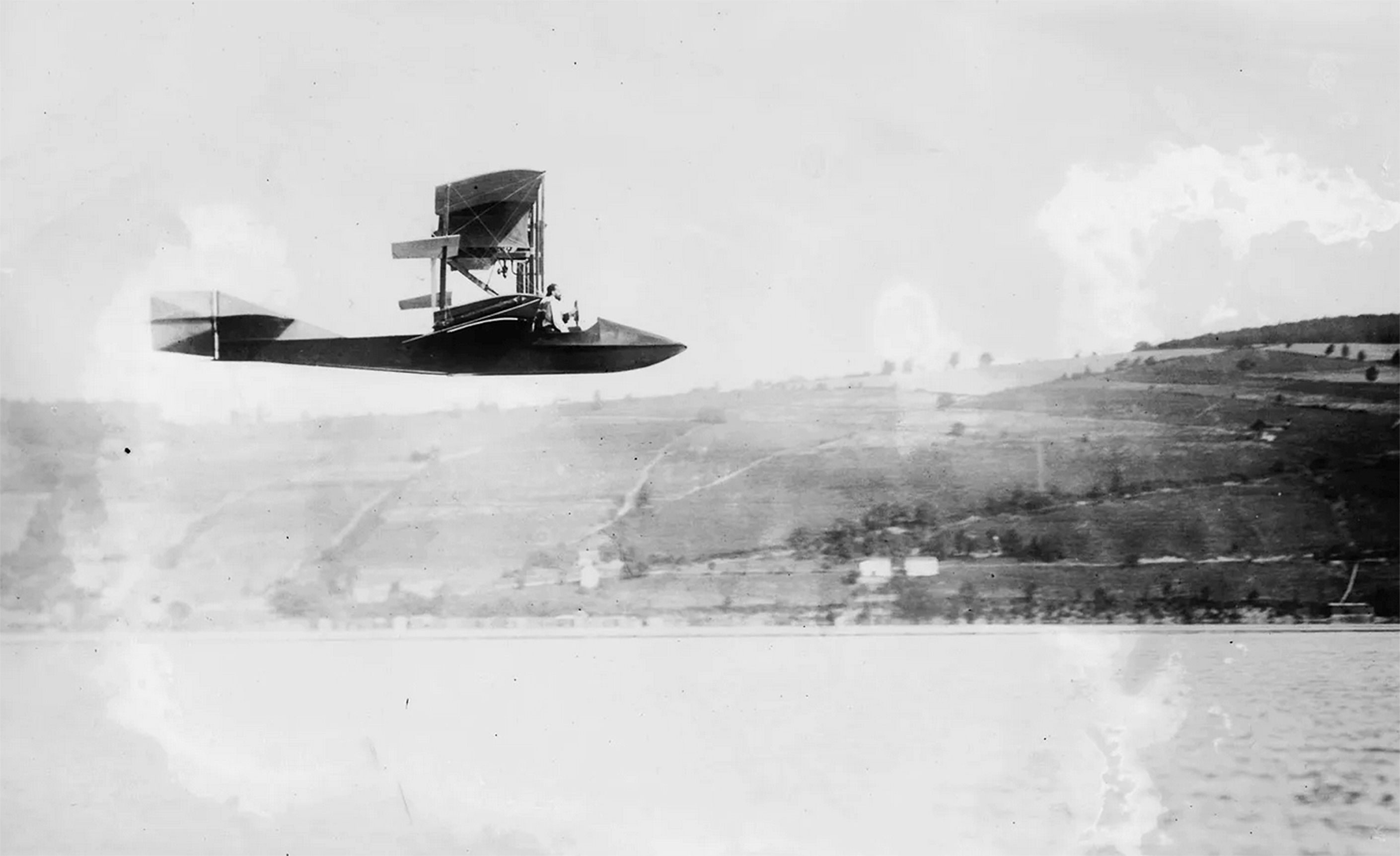 Curtiss "Flying Boat," glass negative, Library of Congress, Flickr Commons Project. Photo probably shows the Flying Fish (Model E), the first "flying boat" produced by Glenn Curtiss, flying over Lake Keuka, New York State, 1912. 