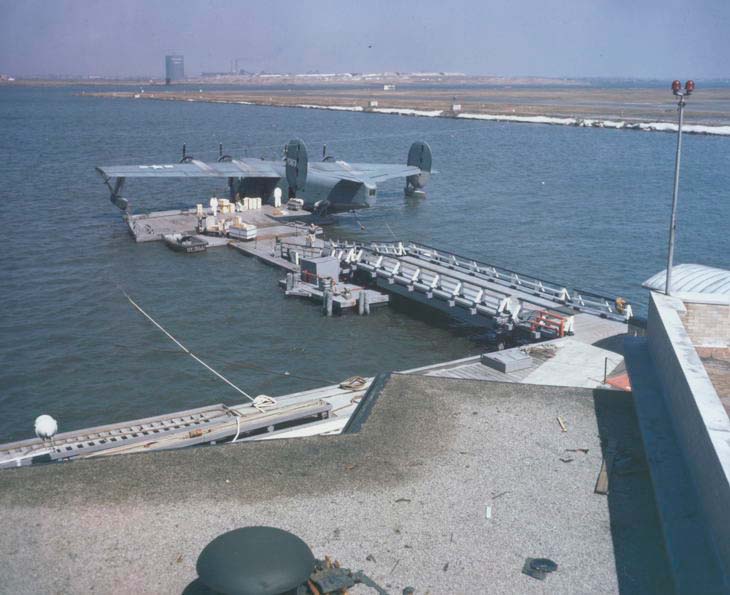 Many Naval Air Transport Service flights were operated by Pan Am Crews. Photo shows a NATS Coronado docked at the Marine Air Terminal.