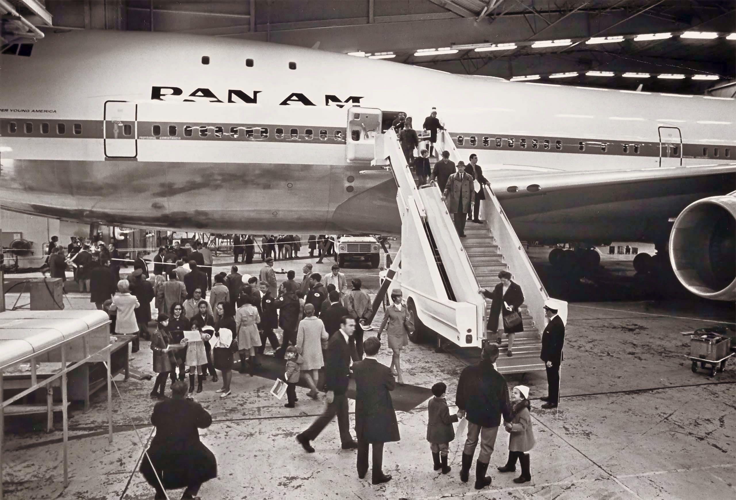 Passengers disembark Clipper Young America with disabled engine, to wait for the backup 747, Clipper Victor, to fly them on the first 747 passenger flight in history from JFK to LHR.