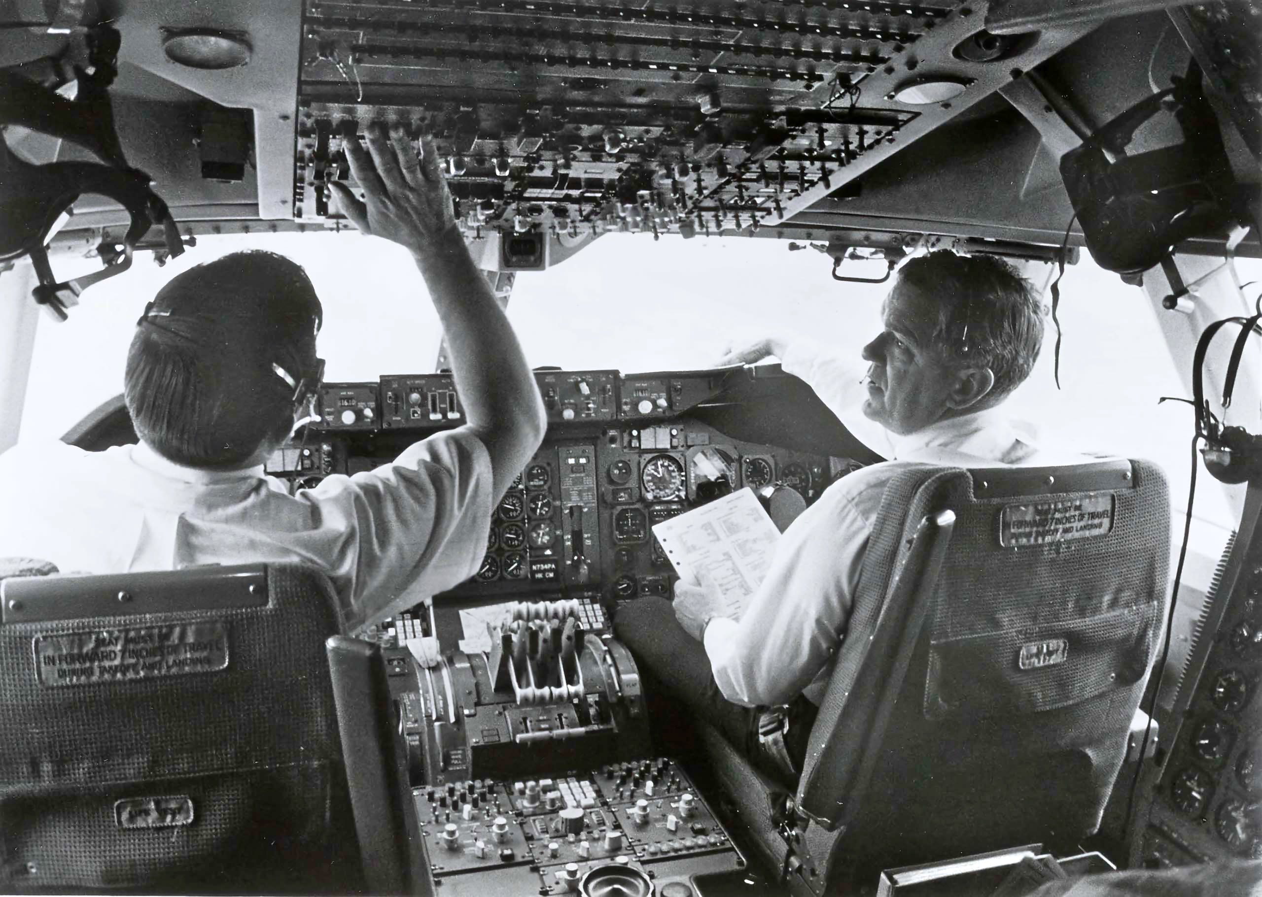 "At Roswell, NM... Pan American World Airways' pilots undergo four to eight hours of flight time in the 747 before being rated on the aircraft by a Federal Aviation Administration inspector. Capt. James C. Waugh (r)... Pan Am's Chief Pilot at Roswell, observes a pilot-trainee run through a check list prior to a training flight" (Pan Am Press Photo, Pan Am Historical Foundation Collection).).