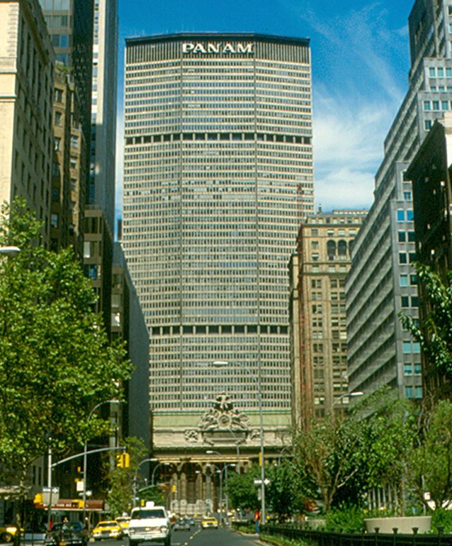 "The Pan Am Building, seen from Park Avenue in 1980.. Grand Central Terminal is in front of it. The Pan Am Building is one of the most recognizable structures in New York. It was opened in 1963. It has 59 floors above ground, and is 808 ft (345 m) high. It is now called the MetLife Building" (Roger Wollstadt, Flicker Creative Commons). https://creativecommons.org/licenses/by-sa/2.0/