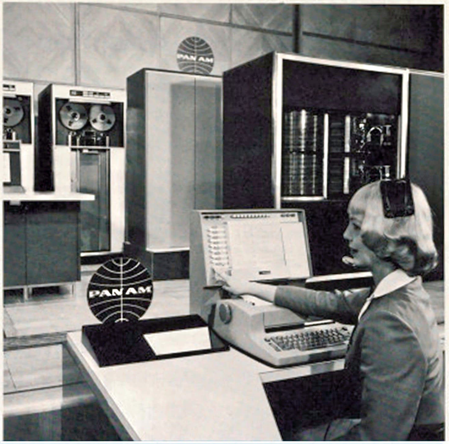 "SHRINKING DISTANCE... Pan American reservations employees thousands of miles away can communicate directly with Panamac to determine space availability or make a reservation. Brenda Lawson, NYDSO, shows reservations set in use; at right are magnetic disc files which can store 500 million characters of information."