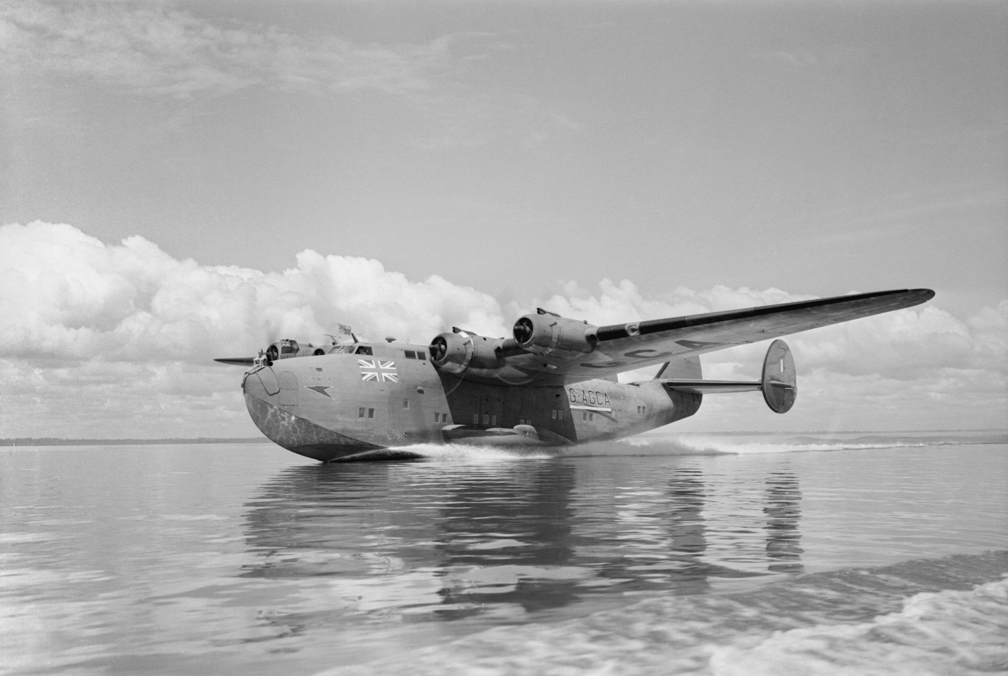 British Overseas Airways Corporation and Qantas, 1940-1945. Boeing Model 314A 'Clipper', G-AGCA "Berwick", of BOAC, lands on Lagos Lagoon, Nigeria, for moorings at the West African flying boat terminal at Iquoi . Clark N S (F/O), Royal Air Force official photographer (Imperial War Museum, via Wikimedia)