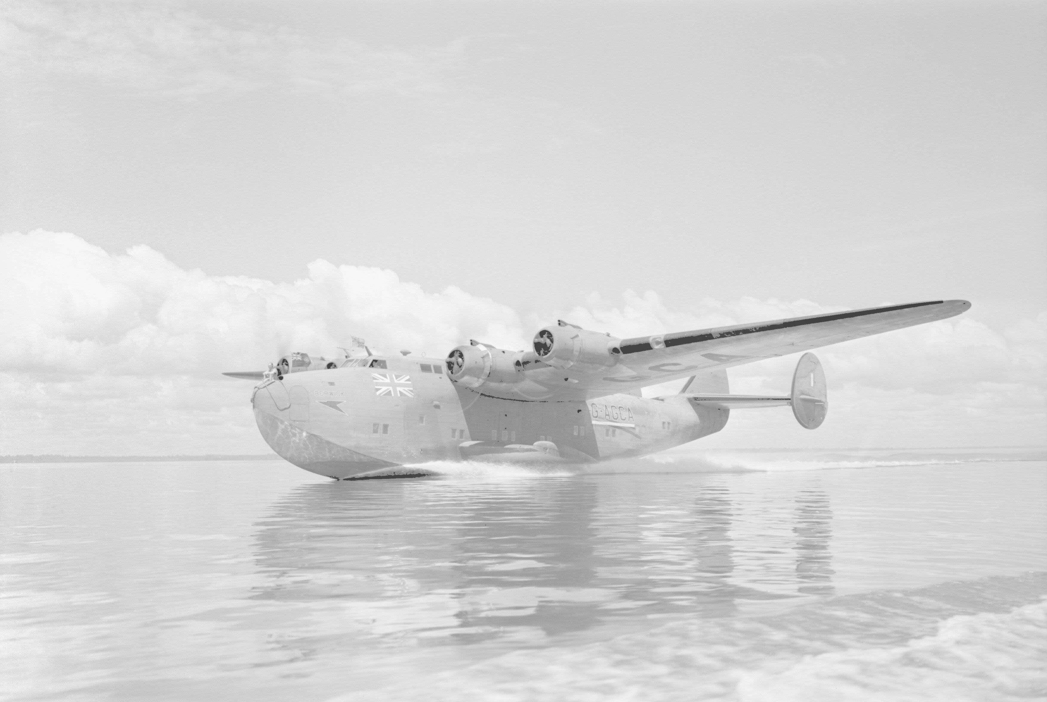British Overseas Airways Corporation and Qantas, 1940-1945. Boeing Model 314A 'Clipper', G-AGCA "Berwick", of BOAC, lands on Lagos Lagoon, Nigeria, for moorings at the West African flying boat terminal at Iquoi . Clark N S (F/O), Royal Air Force official photographer (Imperial War Museum, via Wikimedia)